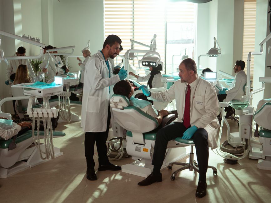 Dental professionals attending to patients in a modern clinic in Baghdad, Iraq.