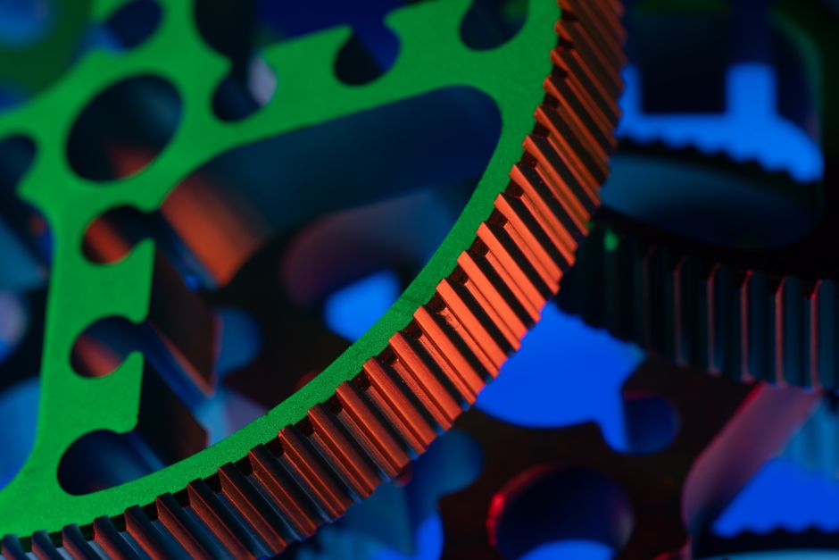 Close-up macro image of vibrant colored gears showcasing precision engineering and industrial mechanics.