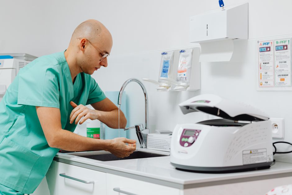 A medical professional practicing hand hygiene in a clinical setting.