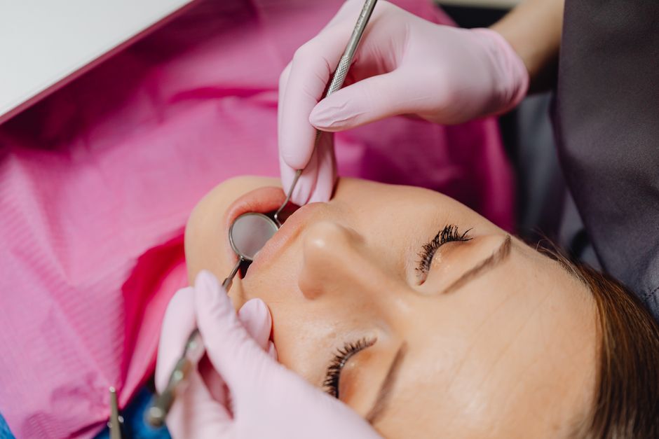 Close-up of a dentist performing a dental examination on a patient.