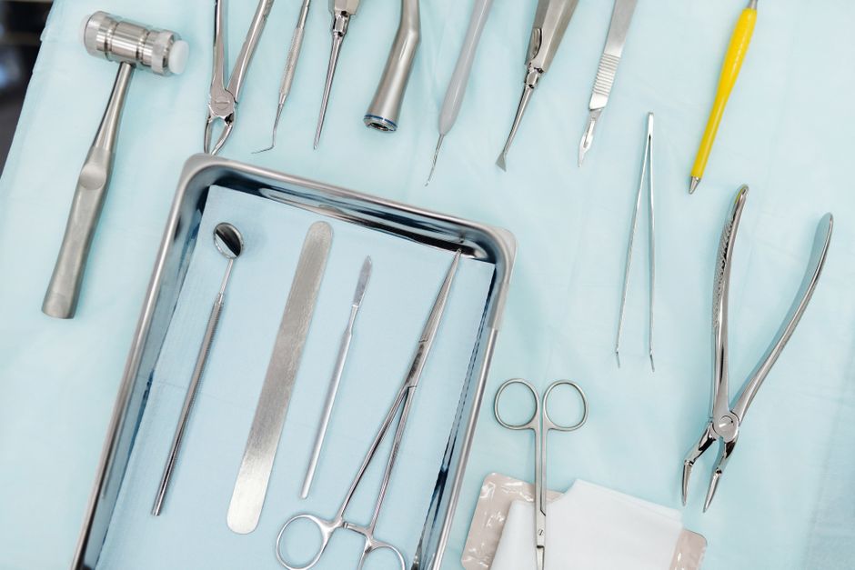 Top view of various dental instruments arranged on a tray, ideal for medical use.