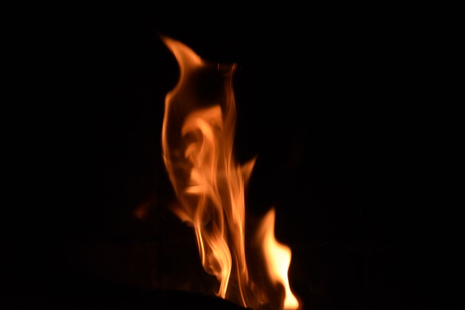 A mesmerizing close-up of dancing flames against a dark backdrop, creating a warm and fiery ambiance.